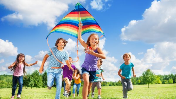 Many active kids with kite